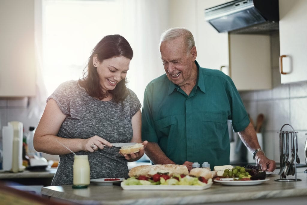 Father and daughter making a sandwich.