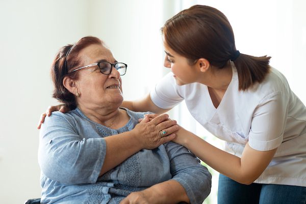 Woman receiving a warm hug from her caregiver as she provides home care in Berkeley, IL