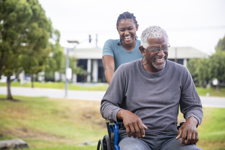 Senior man in wheelchair with daughter